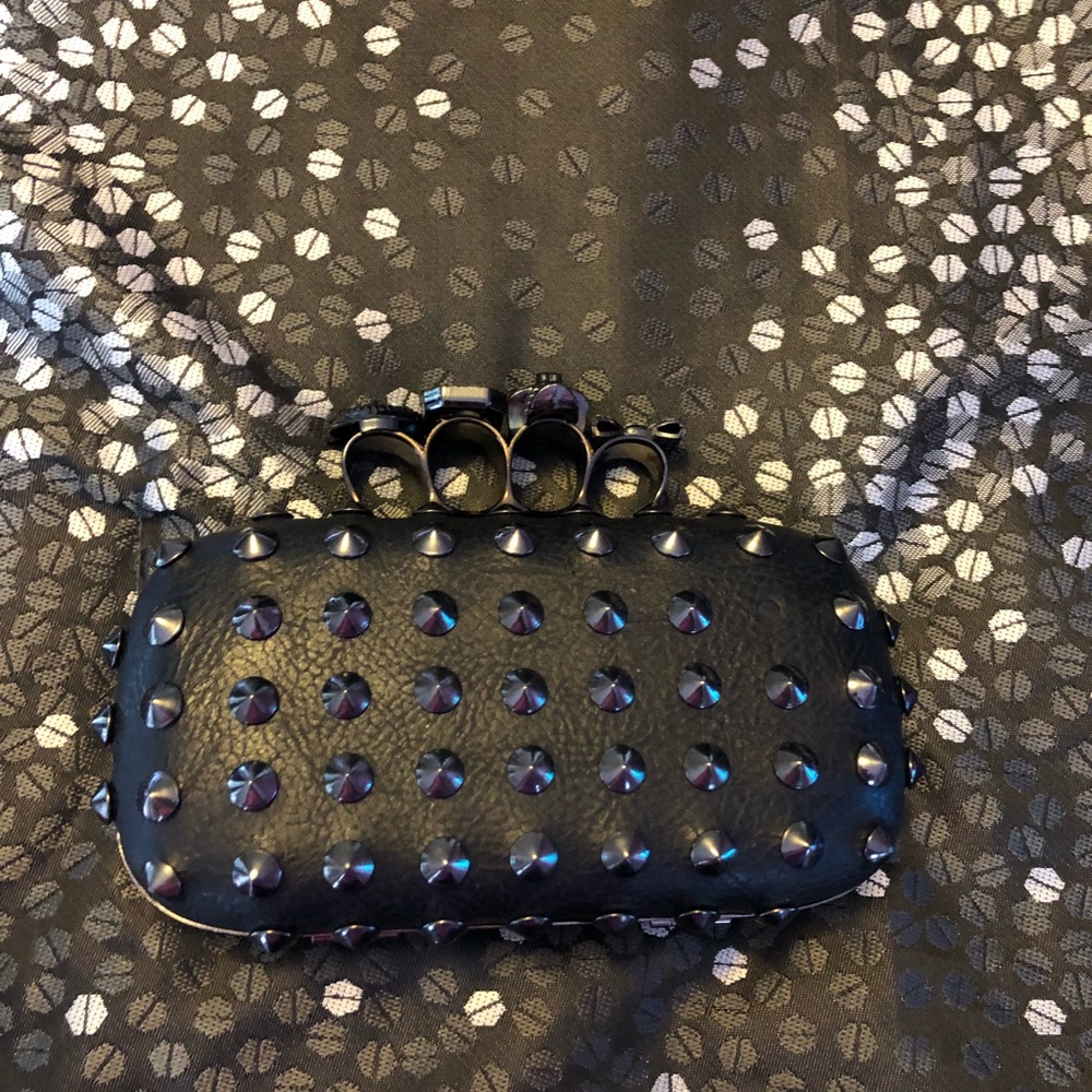 Black studded skull clutch. One stud is missing.